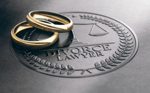 Divorce Lawyer book with two wedding bands.