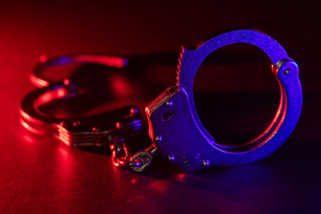 handcuffs and flashing police lights