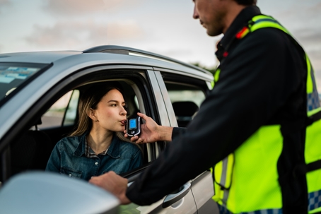 woman taking breathalyzer test